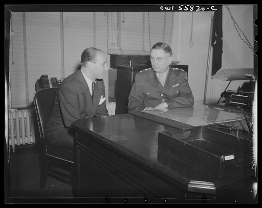 Washington, D.C. Mario Verdi (left), OWI (Office of War Information) radio commentator for Italy, visiting Provost Marshal General Brine