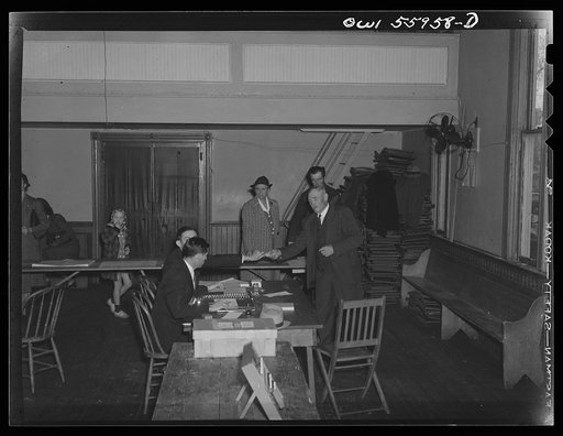Barnesville, Maryland. One of the citizens at the community hall receiving his card which will permit him to cast his ballot on the voting machine in the general election