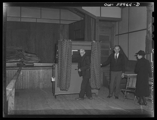 Barnesville, Maryland. This citizen at the community hall has just pulled the lever which parts the curtains and at the same time records his vote on the voting machine in the general election