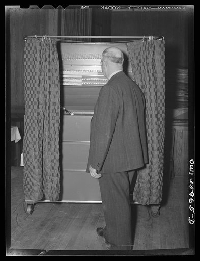 Barnesville, Maryland. This citizen at the community hall going into one of the booths where he will cast his vote in the general election on one of the recently installed voting machines