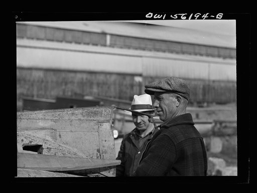 Chester, Pennsylvania. Men repairing their boats by the shore of the Delaware River