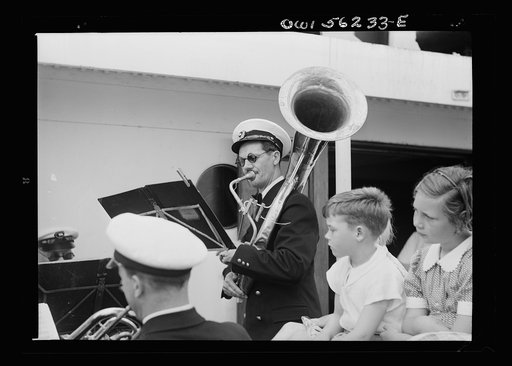 On board a Norwegian-American passenger liner enroute to New York. Children listening to the ship's orchestra