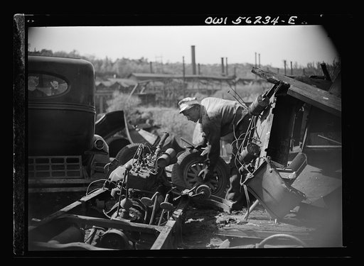 Manayunk, Pennsylvania. Workmen in an automobile junk yard on Ridge Avenue