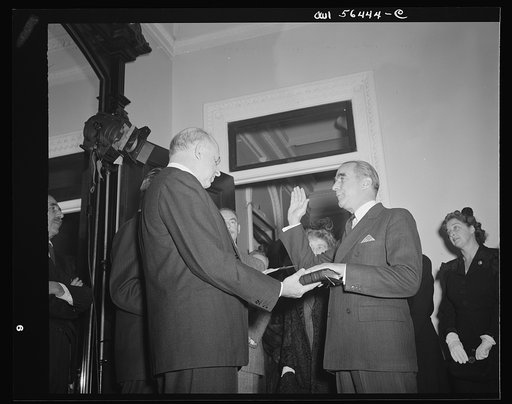 Justice Reed administering oath of office to James C. Dunn, Assistant Secretary in charge of European, Near Eastern, African and Far Eastern affairs