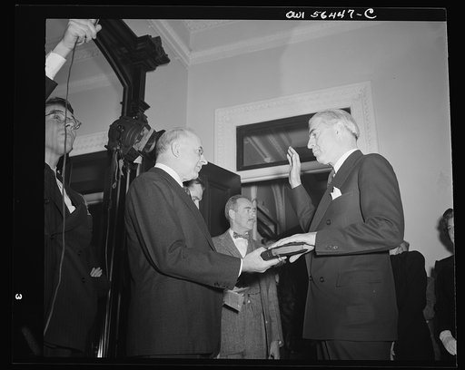Justice Reed administering oath of office to William L. Clayton, Assistant Secretary in charge of Economic Affairs, U.S. Department of State