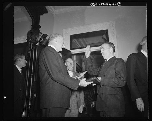 Justice Reed administering oath of office to Archibald MacLeish, Assistant Secretary in charge of Public and Cultural Relations