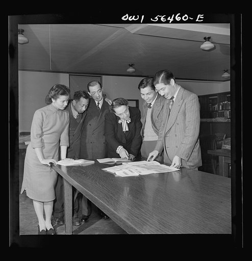 Chinese technical experts inspect reference material in University of Maryland library where they are attending UNRRA (United Nations Relief and Rehabilitation Administration) training center. From left: Miss Ing (from Far Eastern Division, China branch, UNRRA Washington D.C. office); C.C. Chen, N.F