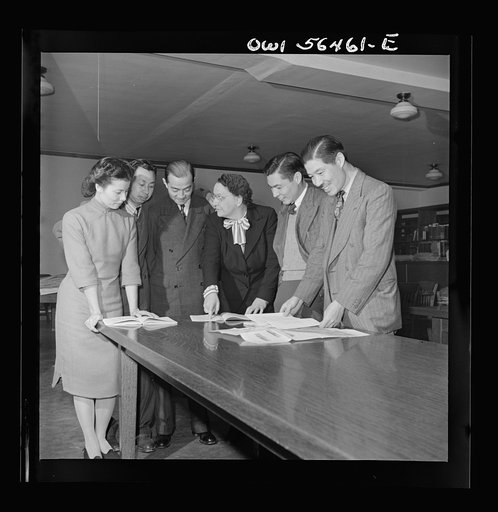 Chinese technical experts inspect reference material in University of Maryland library where they are attending UNRRA (United Nations Relief and Rehabilitation Administration) training center. From left: Miss Ing (from Far Eastern Division, China branch, UNRRA Washington D.C. office); C.C. Chen, N.F