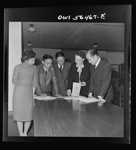 Chinese technical experts inspect reference material in University of Maryland library where they were taking courses offered by the UNRRA (United Nations Relief and Rehabilitation Administration) training center. From left: Miss Ing (from Far Eastern Division, UNRRA Washington  office); H.W. Li; .P