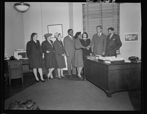 Untitled negative showing (left to right) Grace E. Blackett (United Auto Workers Union, Anne Murkovich (American Federation of Hosiery Workers), Julia O'Connor Parker (International Brotherhood of Electrical Workers) and Maida Stewart Springer (International Ladies' Garment Workers Union) shaking ha