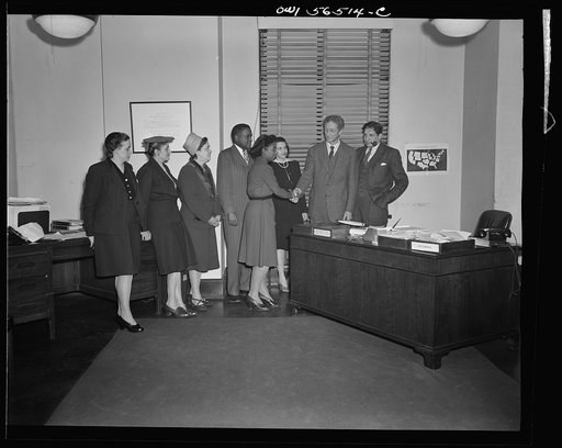 Untitled negative showing (left to right) Grace E. Blackett (United Auto Workers Union), Anne Murkovich (American Federation of Hosiery Workers), Julia O'Connor Parker (International Brotherhood of Electrical Workers) and Maida Stewart Springer (International Ladies' Garment Workers Union) shaking h
