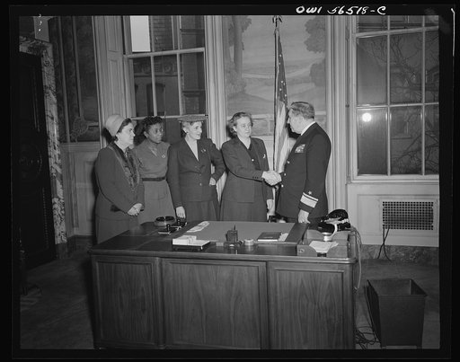 Untitled negative showing (left to right) Julia O'Connor Parker (International Brotherhood of Electrical Workers), Maida Stewart Springer (International Ladies' Garment Workers Union), Anne Murkovich (American Federation of Hosiery Workers) and Grace E. Blackett (United Auto Workers Union) shaking h