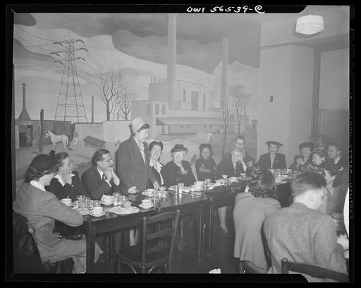Untitled negative showing Julia O'Connor Parker (International Brotherhood of Electrical Workers) standing and speaking in room with mural. Maida Stewart Springer (International Ladies' Garment Workers Union) is seated 7th from left.  Anne Murkovich (American Federation of Hosiery Workers) and Grace