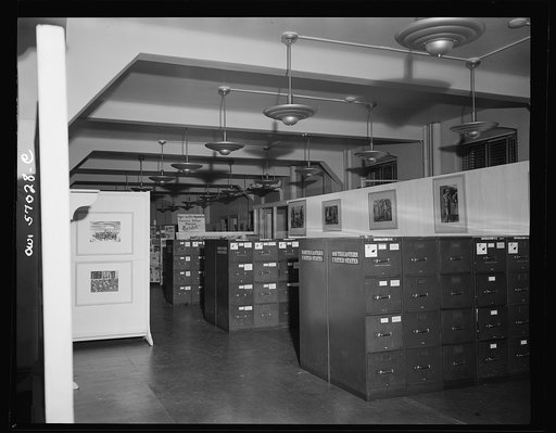 Installation of the United States Office of War Information (OWI) exhibit of original drawings and paintings by artists now in the armed forces. Preview, before shipping to Australia, held at the office of the Overseas Picture Division in the Auditor's Building