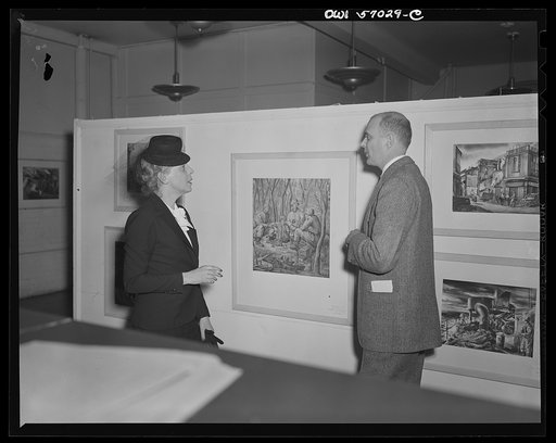 Installation of the United States Office of War Information (OWI) exhibit of original drawings and paintings by artists now in the armed forces. Preview, before shipping to Australia, held at the office of the Overseas Picture Division in the Auditor's Building