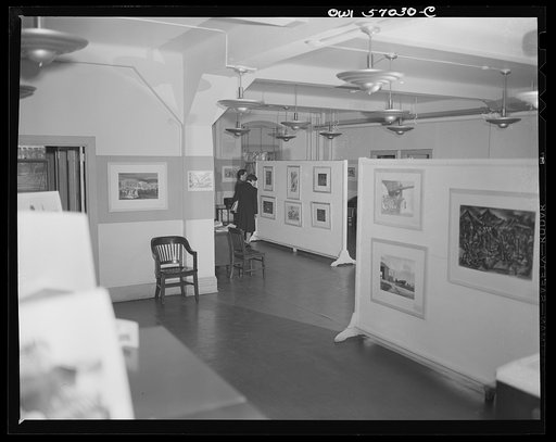 Installation of the United States Office of War Information (OWI) exhibit of original drawings and paintings by artists now in the armed forces. Preview, before shipping to Australia, held at the office of the Overseas Picture Division in the Auditor's Building