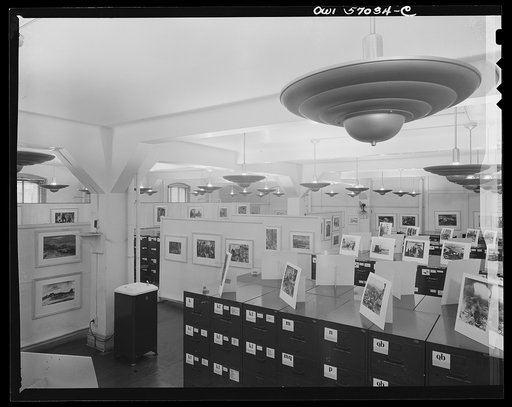 Installation of the United States Office of War Information (OWI) exhibit of original drawings and paintings by artists now in the armed forces. Preview, before shipping to Australia, held at the office of the Overseas Picture Division in the Auditor's Building