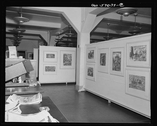 Installation of the United States Office of War Information (OWI) exhibit of original drawings and paintings by artists now in the armed forces. Preview, before shipping to Australia, held at the office of the Overseas Picture Division in the Auditor's Building
