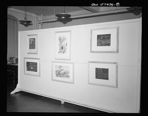 Installation of the United States Office of War Information (OWI) exhibit of original drawings and paintings by artists now in the armed forces. Preview, before shipping to Australia, held at the office of the Overseas Picture Division in the Auditor's Building