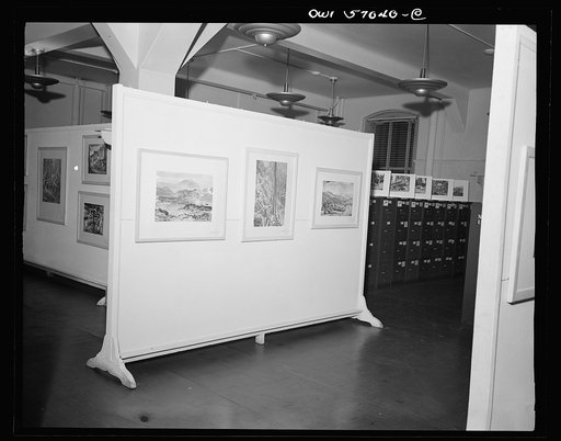 Installation of the United States Office of War Information (OWI) exhibit of original drawings and paintings by artists now in the armed forces. Preview, before shipping to Australia, held at the office of the Overseas Picture Division in the Auditor's Building