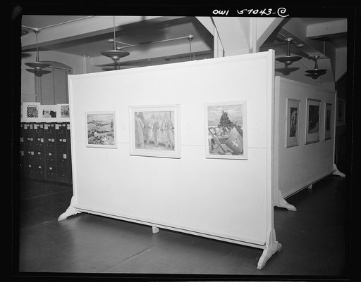Installation of the United States Office of War Information (OWI) exhibit of original drawings and paintings by artists now in the armed forces. Preview, before shipping to Australia, held at the office of the Overseas Picture Division in the Auditor's Building