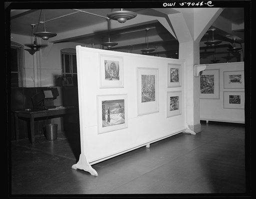 Installation of the United States Office of War Information (OWI) exhibit of original drawings and paintings by artists now in the armed forces. Preview, before shipping to Australia, held at the office of the Overseas Picture Division in the Auditor's Building