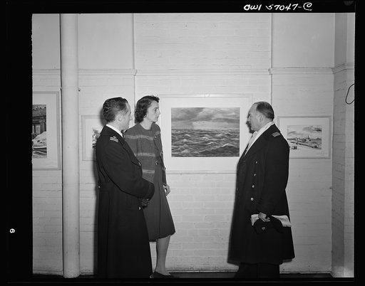 Installation of the United States Office of War Information (OWI) exhibit of original drawings and paintings by artists now in the armed forces. Preview, before shipping to Australia, held at the office of the Overseas Picture Division in the Auditor's Building