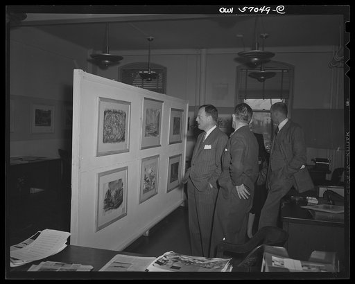 Installation of the United States Office of War Information (OWI) exhibit of original drawings and paintings by artists now in the armed forces. Preview, before shipping to Australia, held at the office of the Overseas Picture Division in the Auditor's Building