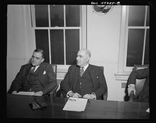 Washington, D.C. Herbert H. Lehman, Director General of the United Nations Relief and Rehabilitation Administration, being interviewed by the press after his return from England and the battlefronts of Europe. Left to right: John Corson, Deputy Director in charge of Finance and Administration, and H