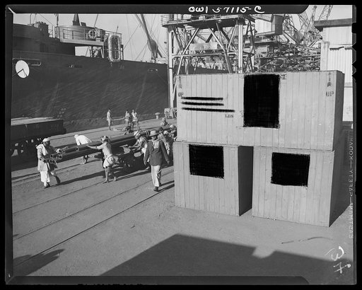 United States "lend-lease" program in eastern India. Lend-lease equipment is unloaded from a Liberty ship at an Indian port