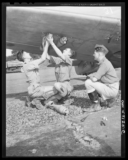 United States "lend-lease" program in eastern India. Royal Air Force ground crew attaches bombs to lend-lease Mohawk fighter. These planes carry six bombs in addition to their six machine-guns. Pilots call the Mohawk the "best answer to the Jap's air power"