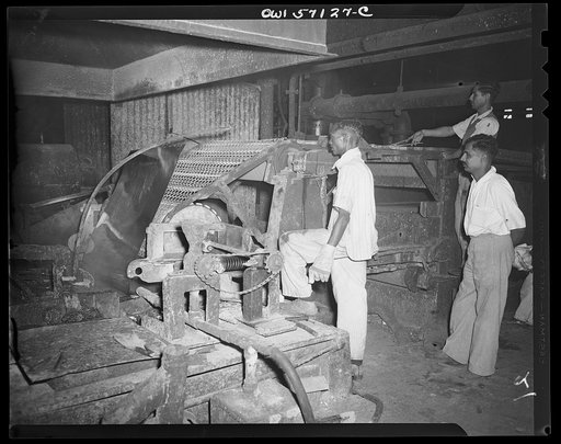 United States "lend-lease" program in eastern India. Galvanizing sheets of steel which have been rolled. Lend-lease furnishes zinc for this important process