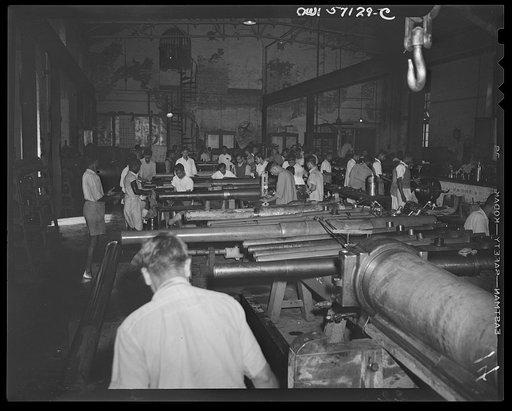 United States "lend-lease" program in eastern India. General view, gun recoditioning. In this "reconditioning room" of an Indian munitions factory, Indian workmen, using lend-lease equipment, help to keep Allied guns in action.