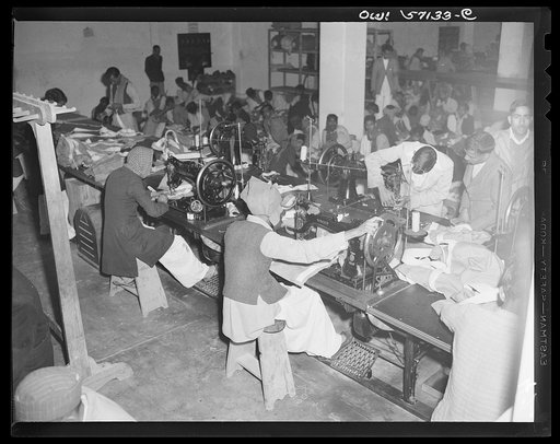 United States "lend-lease" program in eastern India. Indian workmen use lend-lease sewing machines in the manufacture of parachutes