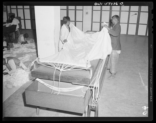 United States "lend-lease" program in eastern India. Indian workmen rigging a newly made parachute. Most of the Singer sewing machines in this factory were supplied under lend-lease
