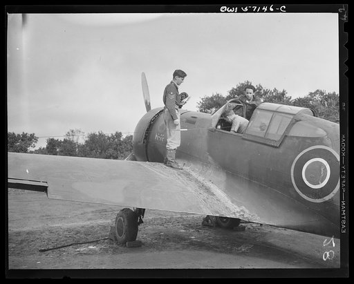 United States "lend-lease" program in eastern India. A Royal Air Force pilot awaits the mechanic's final check before taking off in his lend-lease Mohawk fighter