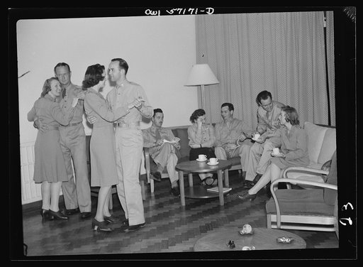 Melbourne, Australia. United States Army hospital. Scene in lounge of nurses' quarters. Left to right: Bertha Olney; Major James Hippel; Julia Owens; Lieutenant Edward Ferreri; Lieutenant E. A. Pearson, Junior; Genevieve Kusek; Captain T. F. Connolly; Lieutenant Ray Loper; Sera Clifton