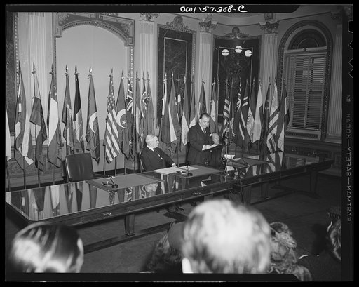 Representatives of Turkey and Egypt sign the Declaration by United Nations. Orhan H. Eral, "Charge d'Affaires ad interim of Turkey" speaks for his county before signing the declaration. Seated left to right, Joseph C. Grew, Undersecretary of State and Mahmond Hassen, Minister of Egypt