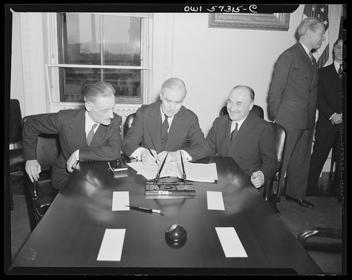 French conclude agreement on lend-lease and reverse lend-lease. Undersecretary of State Joseph C. Grew signs French lend-lease and reverse lend-lease.  Left to right: Henri Bonnet, French Ambassador, Joseph C. Grew, Undersecretary of State and Jean Monnet