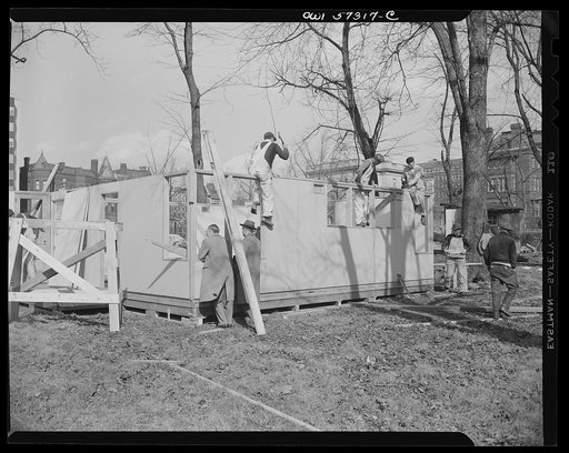 Houses for Britain. Workmen assembling pre-fabricated temporary emergency house of the type which it is planned to ship to Great Britain under lend-lease, at Scott Circle, Washington, D.C. This two-bedroom dwelling was designed to utilize a minimum of critical materials, including lumber. Materials 