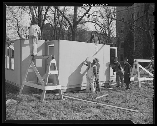 Houses for Britain. Partially assembled pre-fabricated temporary emergency house of the type which it is planned to ship to Great Britain under lend-lease, erected by the Federal Public Housing Authority at Scott Circle, Washington, D.C. Materials have been allotted to FEA by  War Production Board f