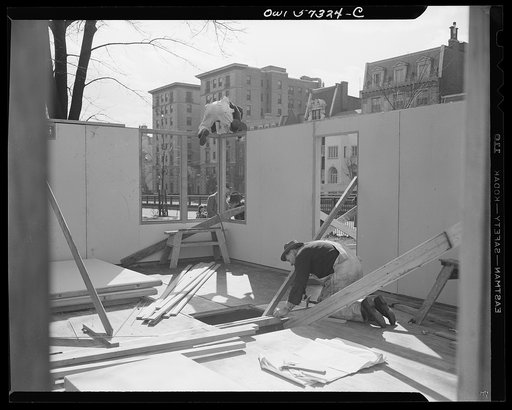 Houses for Britain. Partially assembled pre-fabricated temporary emergency house of the type which it is planned to ship to Great Britain under lend-lease. This sample house was erected by the the Federal Public Housing Authority at Scott Circle, Washington, D.C.