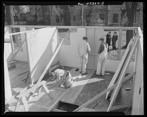 Houses for Britain. Partially assembled pre-fabricated temporary emergency house of the type which it is planned to ship to Great Britain under lend-lease. This sample house was erected by the the Federal Public Housing Authority at Scott Circle, Washington, D.C.