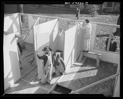 Houses for Britain. Partitions between rooms being put up in model house erected at Scott Circle, Washington, D.C. by the Federal Public Housing Authority, of the type of prefabricated temporary emergency dwelling which United States plans to ship to Great Britiain under lend-lease
