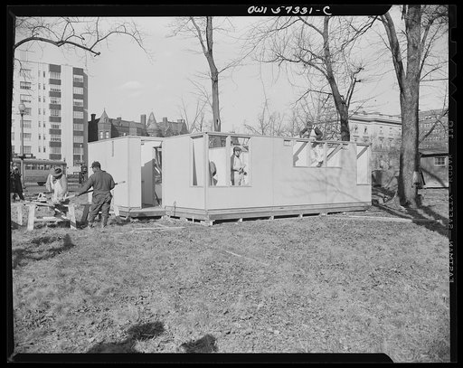 Houses for Britain. Model house under construction at Scott Circle, Washington, D.C., of the type of prefabricated temporary emergency dwelling unit Unitee States plans to ship to Great Britian under lend-lease. Materials have been allotted by  War Production Board, and the Federal Public Housing Au