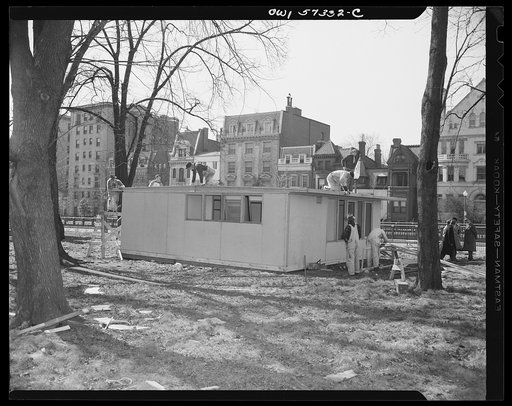 Houses for Britain. Putting finishing touches on roof of model house erected at Scott Circle, Washington, D.C. by the Federal Public Housing Authority. It is planned to ship this type of prefabricated temporary emergency house to Great Britain under lend-lease. War Production Board has allotted mate
