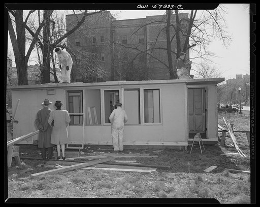Houses for Britain. Model house under construction at Scott Circle, Washington, D.C. It is planned to ship 30,000 of this type of prefabricated temporary emergency dwelling to Great Britain under lend-lease to alleviate acute housing shortage due to bombings.