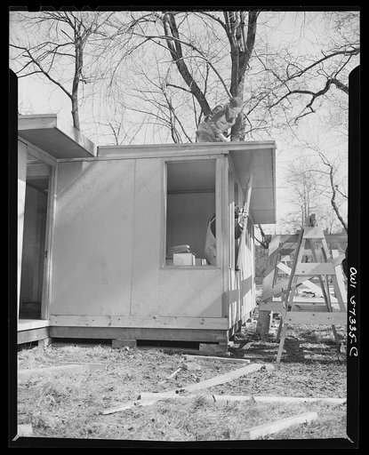 Houses for Britain. Installing windows in kitchen of prefabricated temporary emergency house of the type which the United States will ship to Great Britain under lend-lease. Model house erected by the  Federal Public Housing Authority at Scott Circle, Washington, D.C.