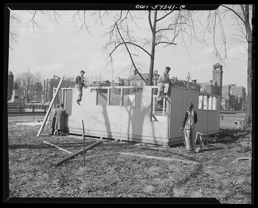 Houses for Britain. With outside walls in place, workmen prepare to put on roof panels on model house erected by the Federal Public Housing Authority at Scott Circle, Washington, D.C. It is planned to ship 30,000 of these pre-fabricated temporary emergency family dwellings to Great Britain under len