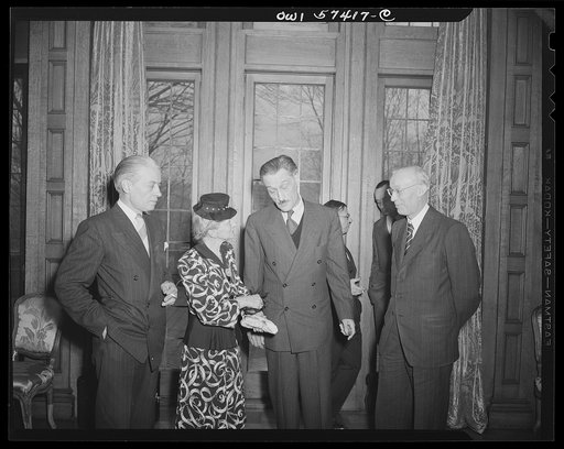 French journalists visiting the United States call on French Ambassador to the United States Henri Bonnet at the French Embassy where a luncheon was given for them March 6, 1945. Left to right: Francois Prieur, Mme Andree Viollis, Ambassador Bonnet and M. Louis Lombard